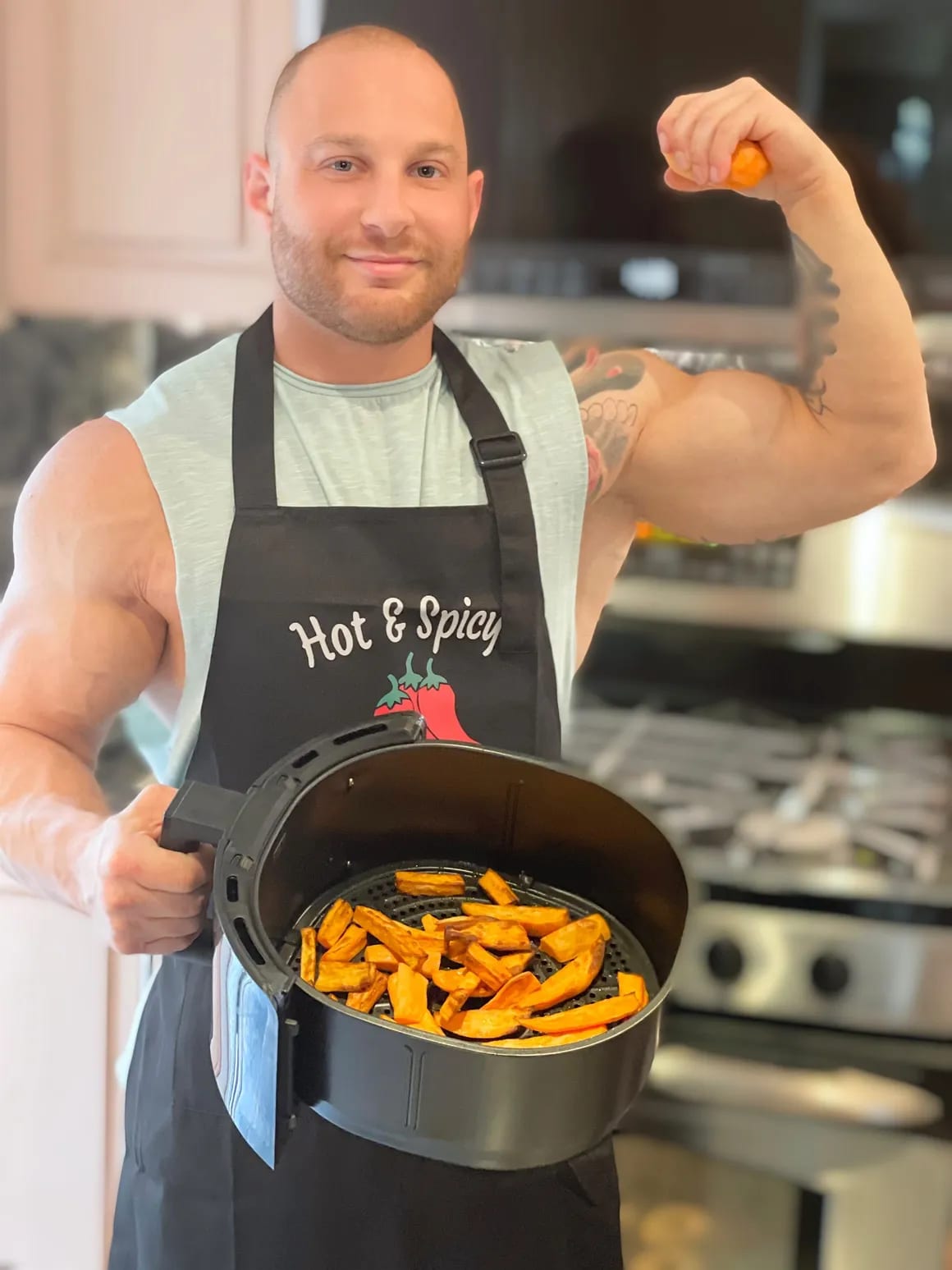 Eitan in his apron plating fresh sweet potato fries